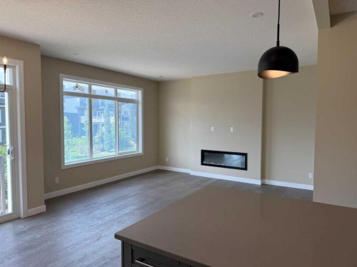 91 Sundown Crescent, Cochrane, AB - Indoor Photo Showing Other Room With Fireplace
