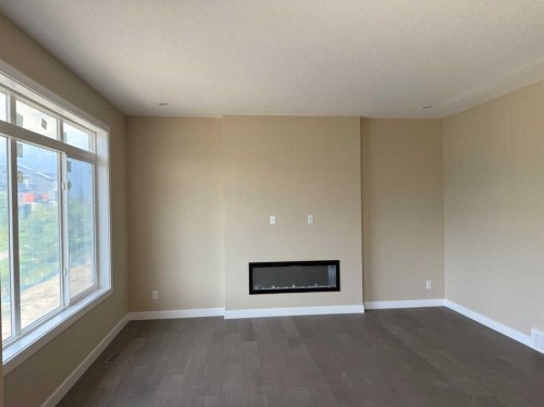 91 Sundown Crescent, Cochrane, AB - Indoor With Fireplace