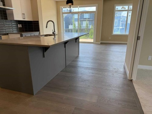 91 Sundown Crescent, Cochrane, AB - Indoor Photo Showing Kitchen With Upgraded Kitchen