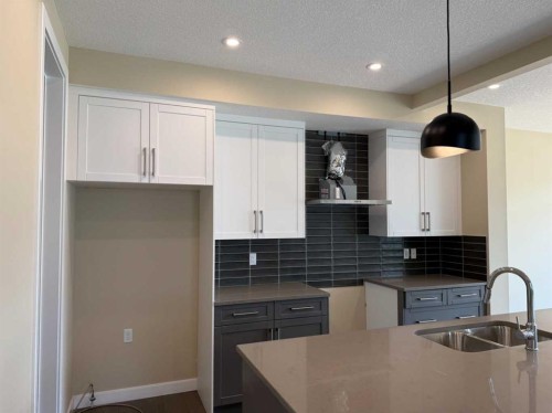 91 Sundown Crescent, Cochrane, AB - Indoor Photo Showing Kitchen With Double Sink With Upgraded Kitchen