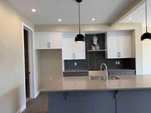 91 Sundown Crescent, Cochrane, AB - Indoor Photo Showing Kitchen With Double Sink With Upgraded Kitchen