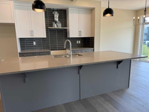 91 Sundown Crescent, Cochrane, AB - Indoor Photo Showing Kitchen With Double Sink