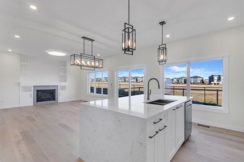 14 Ranchers Meadows, Okotoks, AB - Indoor Photo Showing Kitchen With Fireplace
