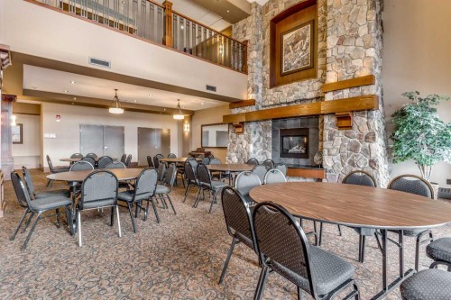 2347-2330 Fish Creek Boulevard Sw, Calgary, AB - Indoor Photo Showing Dining Room With Fireplace