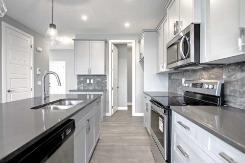 47 Agate Road, Cochrane, AB - Indoor Photo Showing Kitchen With Double Sink With Upgraded Kitchen