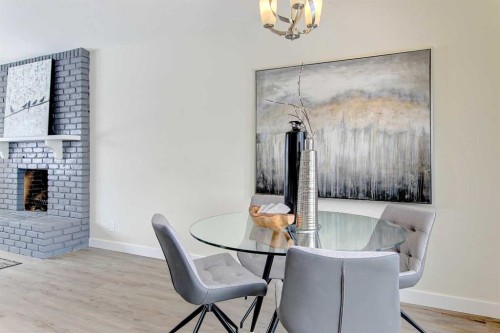 272 Acadia Drive Se, Calgary, AB - Indoor Photo Showing Dining Room With Fireplace