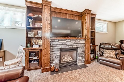 52 Winter Drive, Olds, AB - Indoor Photo Showing Other Room With Fireplace