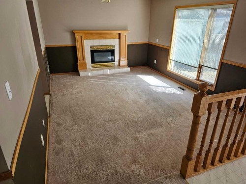 302 Meadowbrook Bay Se, Airdrie, AB - Indoor With Fireplace