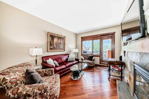 311-1002 8 Avenue, Canmore, AB - Indoor Photo Showing Living Room With Fireplace