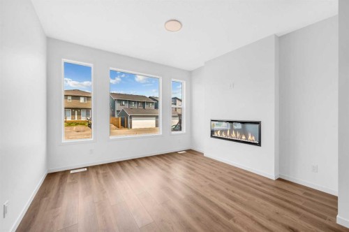 32 Rowmont Common Nw, Calgary, AB - Indoor Photo Showing Living Room With Fireplace