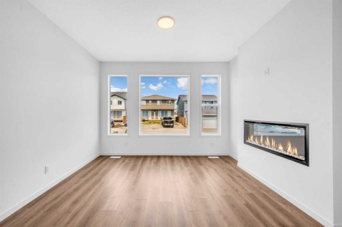 32 Rowmont Common Nw, Calgary, AB - Indoor Photo Showing Living Room With Fireplace