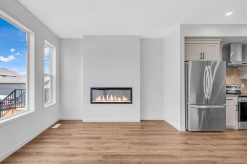 32 Rowmont Common Nw, Calgary, AB - Indoor With Fireplace