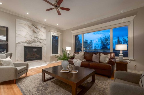 57 Slopes Point Sw, Calgary, AB - Indoor Photo Showing Living Room With Fireplace