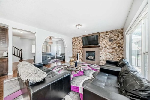 104 Panamount Terrace Nw, Calgary, AB - Indoor Photo Showing Living Room With Fireplace