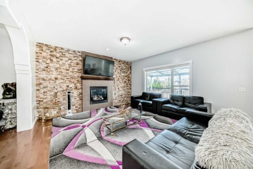 104 Panamount Terrace Nw, Calgary, AB - Indoor Photo Showing Living Room With Fireplace