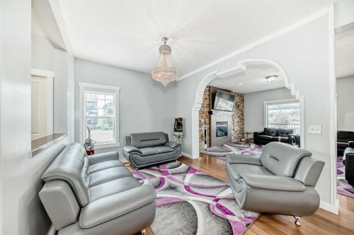104 Panamount Terrace Nw, Calgary, AB - Indoor Photo Showing Living Room With Fireplace