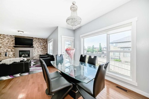 104 Panamount Terrace Nw, Calgary, AB - Indoor Photo Showing Dining Room With Fireplace