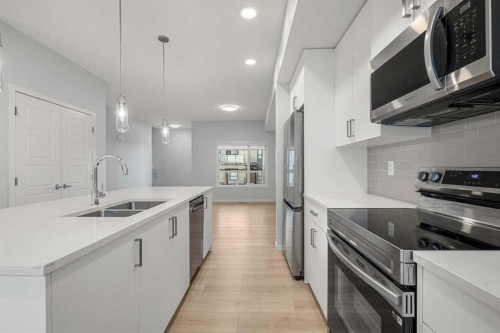 408-20295 Seton Way Se, Calgary, AB - Indoor Photo Showing Kitchen With Double Sink With Upgraded Kitchen