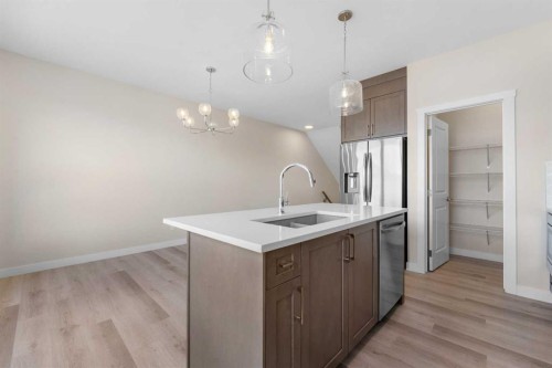 121 Wild Rose Way Se, Calgary, AB - Indoor Photo Showing Kitchen With Double Sink With Upgraded Kitchen