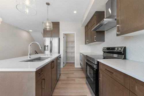 121 Wild Rose Way Se, Calgary, AB - Indoor Photo Showing Kitchen With Double Sink With Upgraded Kitchen