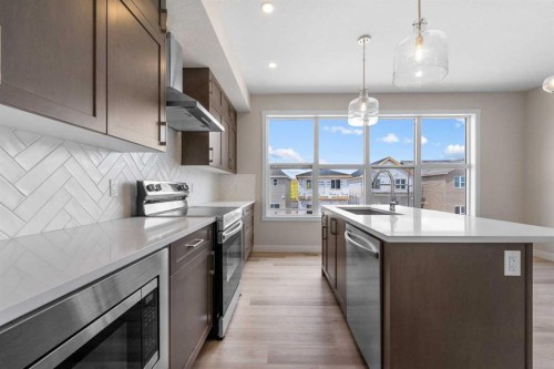 121 Wild Rose Way Se, Calgary, AB - Indoor Photo Showing Kitchen With Upgraded Kitchen