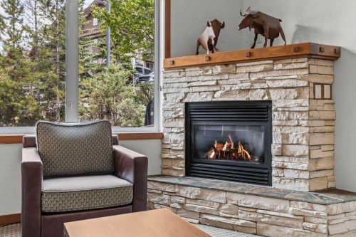 109-190 Kananaskis Way, Canmore, AB - Indoor Photo Showing Living Room With Fireplace