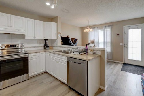 22 Tarington Landing Ne, Calgary, AB - Indoor Photo Showing Kitchen With Double Sink