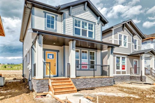 426 Heartland Way, Cochrane, AB - Outdoor With Deck Patio Veranda With Facade