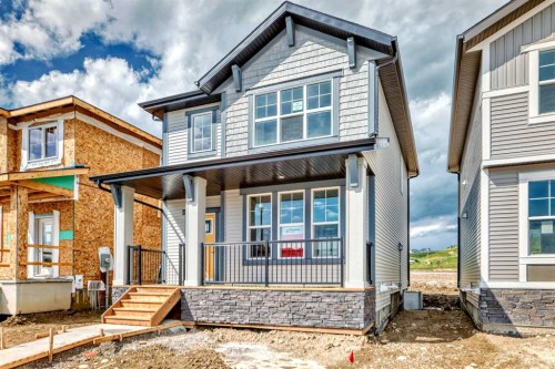 426 Heartland Way, Cochrane, AB - Outdoor With Deck Patio Veranda With Facade