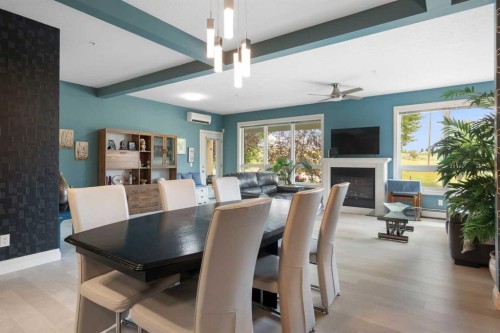 2110-10221 Tuscany Boulevard Nw, Calgary, AB - Indoor Photo Showing Dining Room With Fireplace