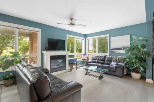 2110-10221 Tuscany Boulevard Nw, Calgary, AB - Indoor Photo Showing Living Room With Fireplace