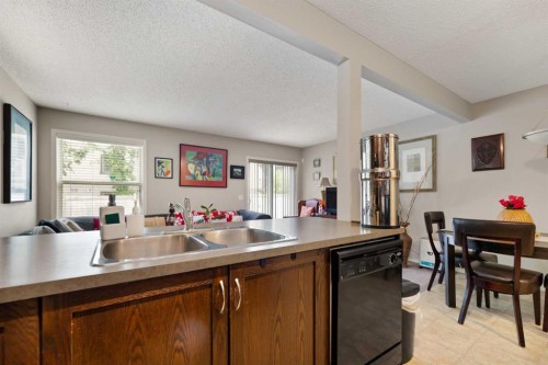 90 Panatella Villas Nw, Calgary, AB - Indoor Photo Showing Kitchen With Double Sink