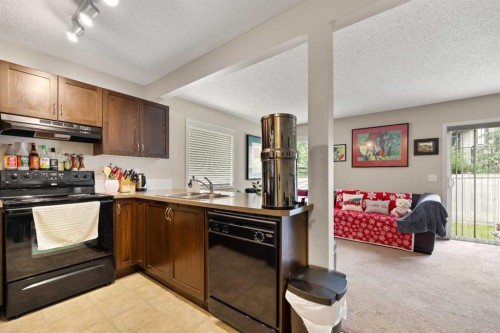 90 Panatella Villas Nw, Calgary, AB - Indoor Photo Showing Kitchen With Double Sink