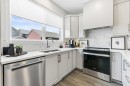 63 Heirloom Boulevard Se, Calgary, AB  - Indoor Photo Showing Kitchen With Stainless Steel Kitchen With Double Sink 