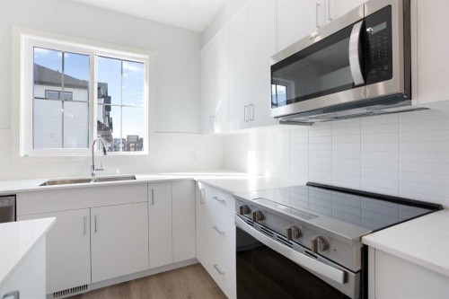 406-1750 Rangeview Drive Se, Calgary, AB - Indoor Photo Showing Kitchen With Double Sink With Upgraded Kitchen