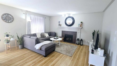 1156 Sherwood Boulevard Nw, Calgary, AB - Indoor Photo Showing Living Room With Fireplace