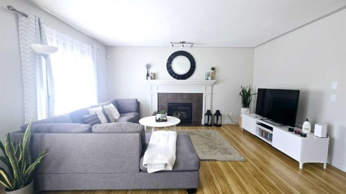 1156 Sherwood Boulevard Nw, Calgary, AB - Indoor Photo Showing Living Room With Fireplace