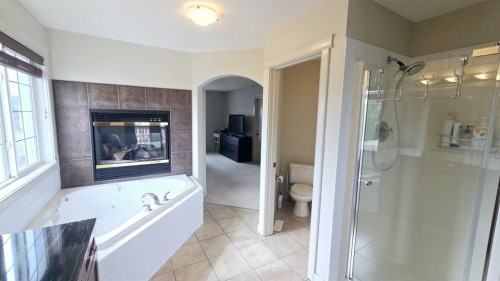 1156 Sherwood Boulevard Nw, Calgary, AB - Indoor Photo Showing Bathroom With Fireplace