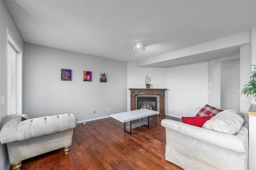 69 Royal Elm Mews, Calgary, AB - Indoor Photo Showing Living Room With Fireplace