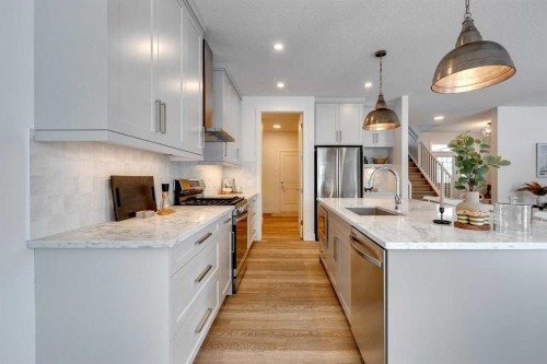 483 Rivercrest View, Cochrane, AB - Indoor Photo Showing Kitchen With Upgraded Kitchen