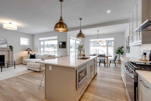 483 Rivercrest View, Cochrane, AB - Indoor Photo Showing Kitchen With Fireplace With Upgraded Kitchen