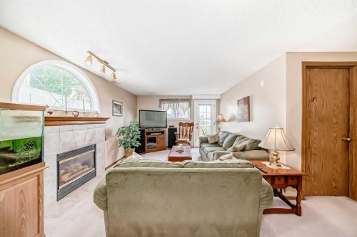 76 Hidden Way Nw, Calgary, AB - Indoor Photo Showing Living Room With Fireplace
