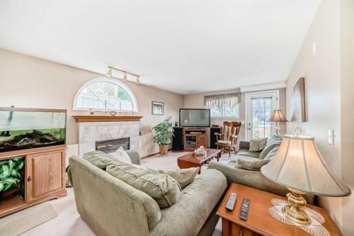 76 Hidden Way Nw, Calgary, AB - Indoor Photo Showing Living Room With Fireplace
