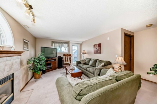 76 Hidden Way Nw, Calgary, AB - Indoor Photo Showing Living Room With Fireplace