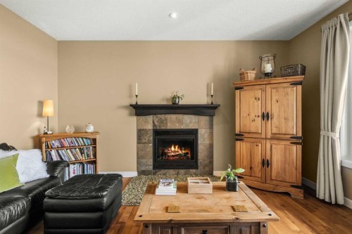 653 West Highland Crescent, Carstairs, AB - Indoor Photo Showing Living Room With Fireplace