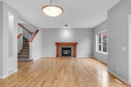 1500 Copperfield Boulevard Se, Calgary, AB - Indoor Photo Showing Living Room With Fireplace
