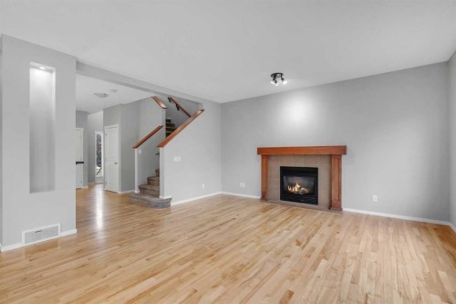1500 Copperfield Boulevard Se, Calgary, AB - Indoor Photo Showing Living Room With Fireplace