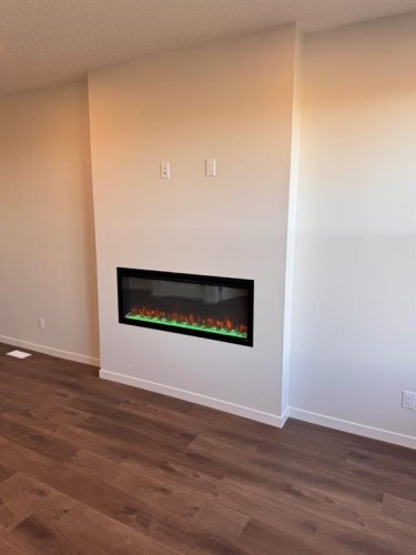 232 Ricardo Ranch Drive Se, Calgary, AB - Indoor Photo Showing Living Room With Fireplace