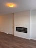 17 Setonvista Gate Se, Calgary, AB  - Indoor Photo Showing Living Room With Fireplace 
