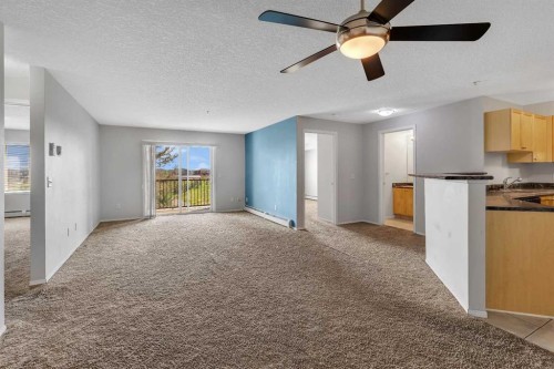 6307-304 Mackenzie Way Sw, Airdrie, AB - Indoor Photo Showing Kitchen